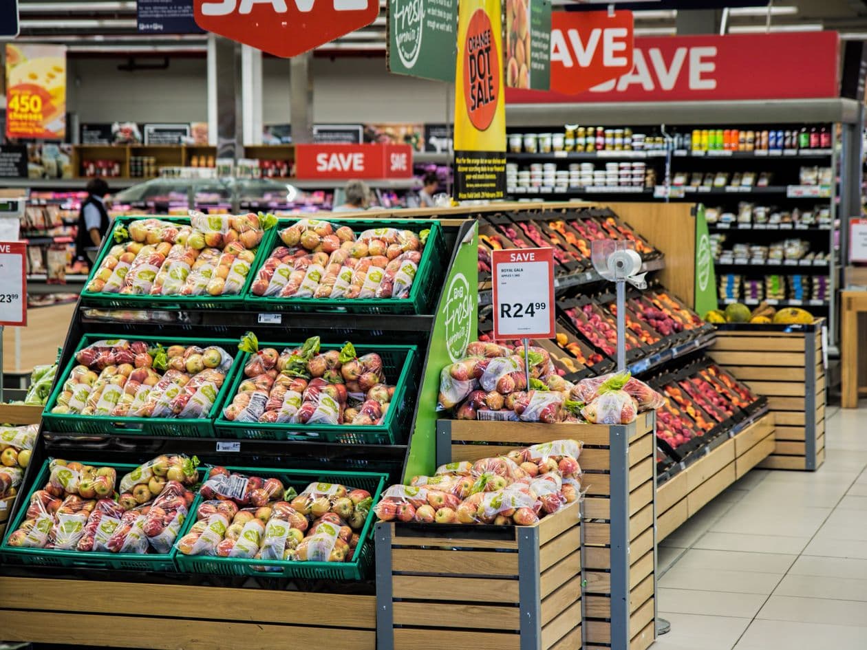 Supermarket produce aisle with retail signage — retail and trade marketing