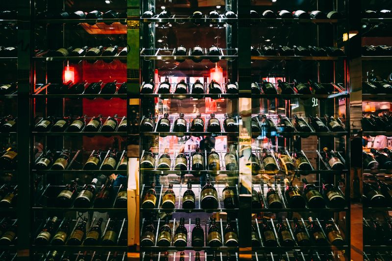 Rows of wine and spirit bottles on shelves at an upscale bar. — Photo on Pexels