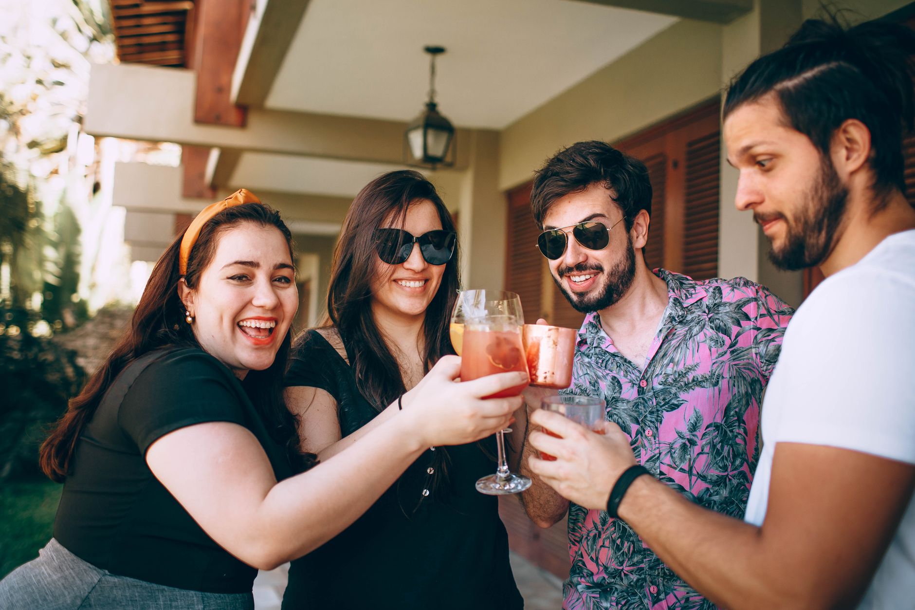 Happy group of friends enjoying a toast with drinks outdoors. — Photo by Helena Lopes on Pexels